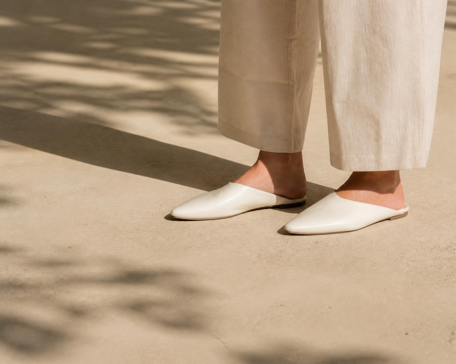 Off-white TwoStep slippers worn on sunlit concrete