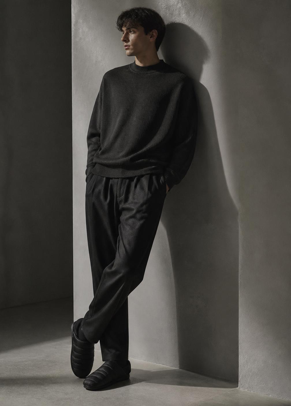 Black padded slippers styled with dark tailoring